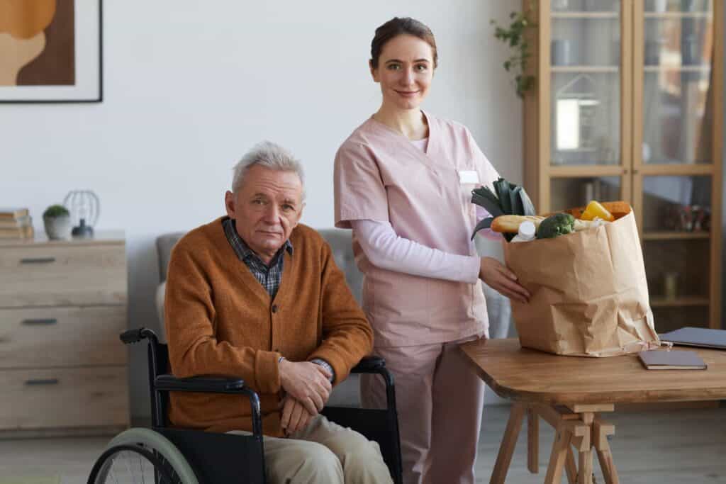 Portrait Of Disabled Senior Man With Female Caregiver E1638524707320 1024x683